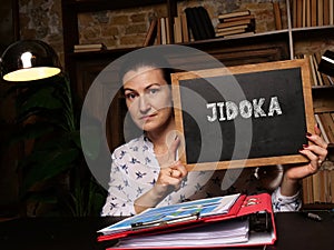 Business concept about JIDOKA with inscription on black chalkboard photo