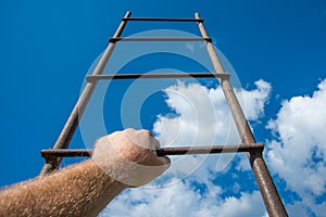 Business concept, a man hand a first-person view rises the ladder to the sky. Career