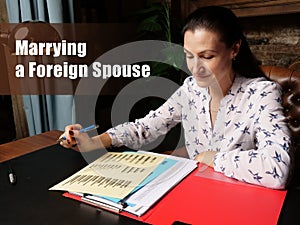 Business concept about Marrying a Foreign Spouse Female office workers with yellow shirt holding and writing documents on office photo