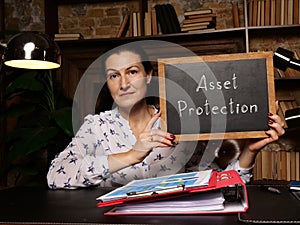 Business concept meaning Asset Protection with phrase on black chalkboard in hand