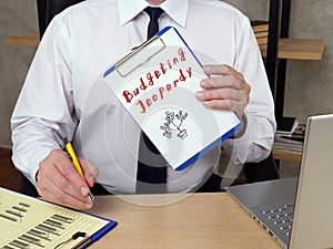 Business concept meaning Budgeting Jeopardy H with inscription on the piece of paper photo