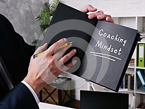 Business concept meaning Coaching Mindset with phrase on the sheet