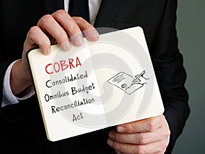 Business concept meaning COBRA Consolidated Omnibus Budget Reconciliation Act with phrase on the page photo