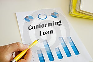 Business concept meaning Conforming Loan with sign on the chart sheet photo