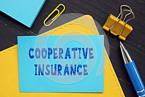 Business concept meaning COOPERATIVE INSURANCE with sign on the business paper