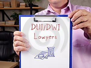 Business concept meaning DUI/DWI Lawyers with sign on the piece of paper