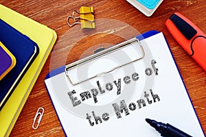 Business concept meaning Employee of the Month with inscription on the sheet