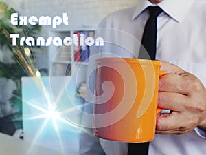 Business concept meaning Exempt Transaction with Man with a cup of coffee in the background