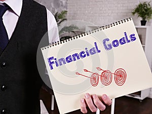 Business concept meaning Financial Goals with sign on the piece of paper