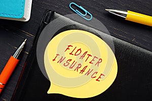 Business concept meaning FLOATER INSURANCE with sign on the business paper