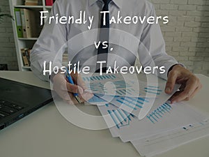 Business concept meaning Friendly Takeovers vs. Hostile Takeovers with inscription on the sheet