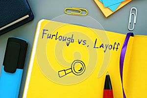 Business concept meaning Furlough vs Layoff with inscription on the sheet photo