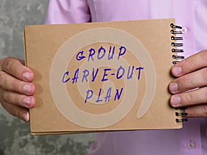 Business concept meaning GROUP CARVE-OUT PLAN with phrase on the piece of paper