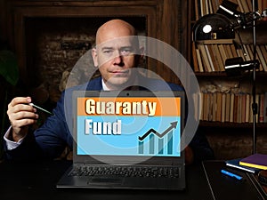 Business concept meaning Guaranty Fund with phrase on laptop in hand