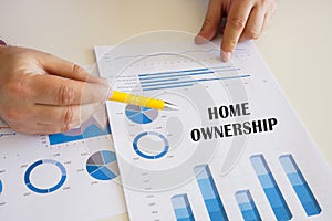 Business concept meaning HOME OWNERSHIP with inscription on the printout with diagrams and tables