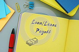 Business concept meaning Loan/Lease Payoff with inscription on the piece of paper