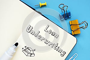 Business concept meaning Loan Underwriting with sign on the sheet