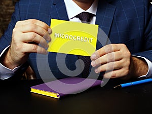 Business concept meaning MICROCREDIT with inscription on the sheet. Creative photo about microfinance that involves an extremely