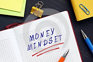 Business concept meaning MONEY MINDSET with sign on the piece of paper. A money mindset is an overriding attitude that you have