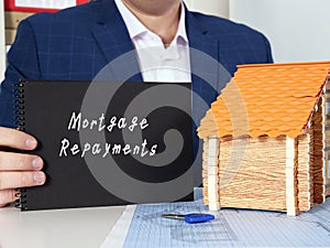 Business concept meaning Mortgage Repayments with inscription on black notepad photo