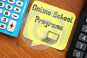 Business concept meaning Online School Programs with sign on the piece of paper