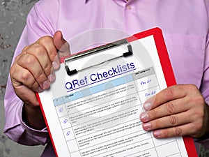 Business concept meaning QRef Checklists with sign on the page
