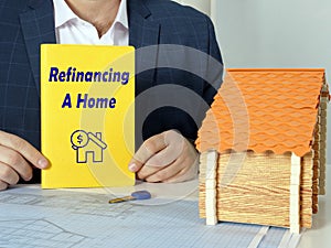 Business concept meaning Refinancing A Home with phrase on yellow book