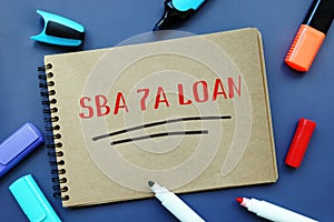 Business concept meaning SBA 7A LOAN Small Business Administration with sign on the piece of paper