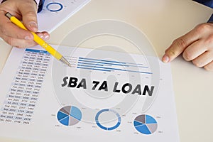 Business concept meaning SBA 7A LOAN with phrase on the printout with diagrams and tables photo