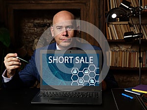 Business concept meaning SHORT SALE with phrase on the laptop. Business photo shows the sale of an asset or stock that the seller
