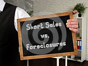 Business concept meaning Short Sales vs. Foreclosures with sign on the sheet