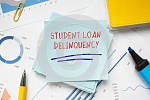 Business concept meaning STUDENT LOAN DELINQUENCY with phrase on the piece of paper photo