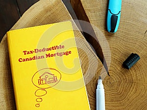 Business concept meaning Tax-Deductible Canadian Mortgage with phrase on the sheet