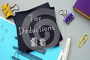 Business concept meaning Tax Deductions with inscription on the sheet