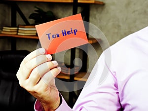Business concept meaning  Tax Help    with inscription on the piece of paper