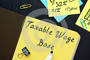 Business concept meaning Taxable Wage Base with sign on the sheet photo