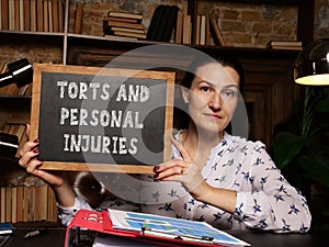 Business concept meaning TORTS AND PERSONAL INJURIES with inscription on the chalkboard