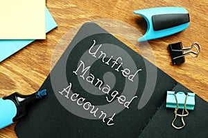 Business concept meaning Unified Managed Account UMA with sign on the sheet