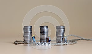 Business concept with a miniature people with a pile of coins.