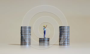 Business concept with a miniature person with a pile of coins.