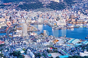 Business concept, modern cityscape of nagasaki dusk from mount inasa, the new top 3 nightview of the world, aerial view, copy