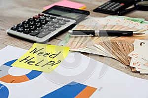 Business concept. Money, calculator and business graph on the table. The inscription needs help.