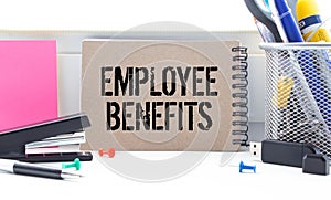Business concept. Notebook with text Employee Benefits sheet of white paper
