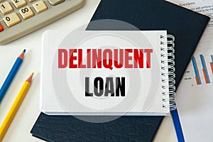 Business concept - notebook writing Delinquent loan