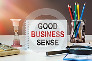 Business concept - notebook writing GOOD BUSINESS SENSE