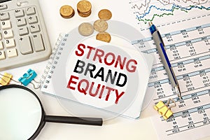 Business concept - notebook writing STRONG BRAND EQUITY