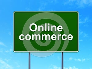 Business concept: Online Commerce on road sign background