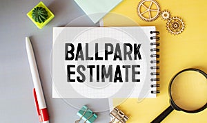 Business concept. open notepad with text on calendar - BALLPARK ESTIMATE