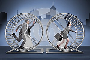 The business concept with pair running on hamster wheel