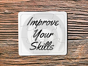 Phrase improve your skills written on puzzle board.